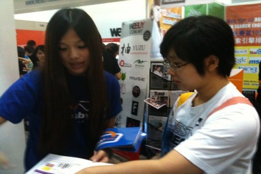 Our exhibition helper distributing flyers and explaining to customers on how one can instantly start his/her own web store and start selling on Facebook